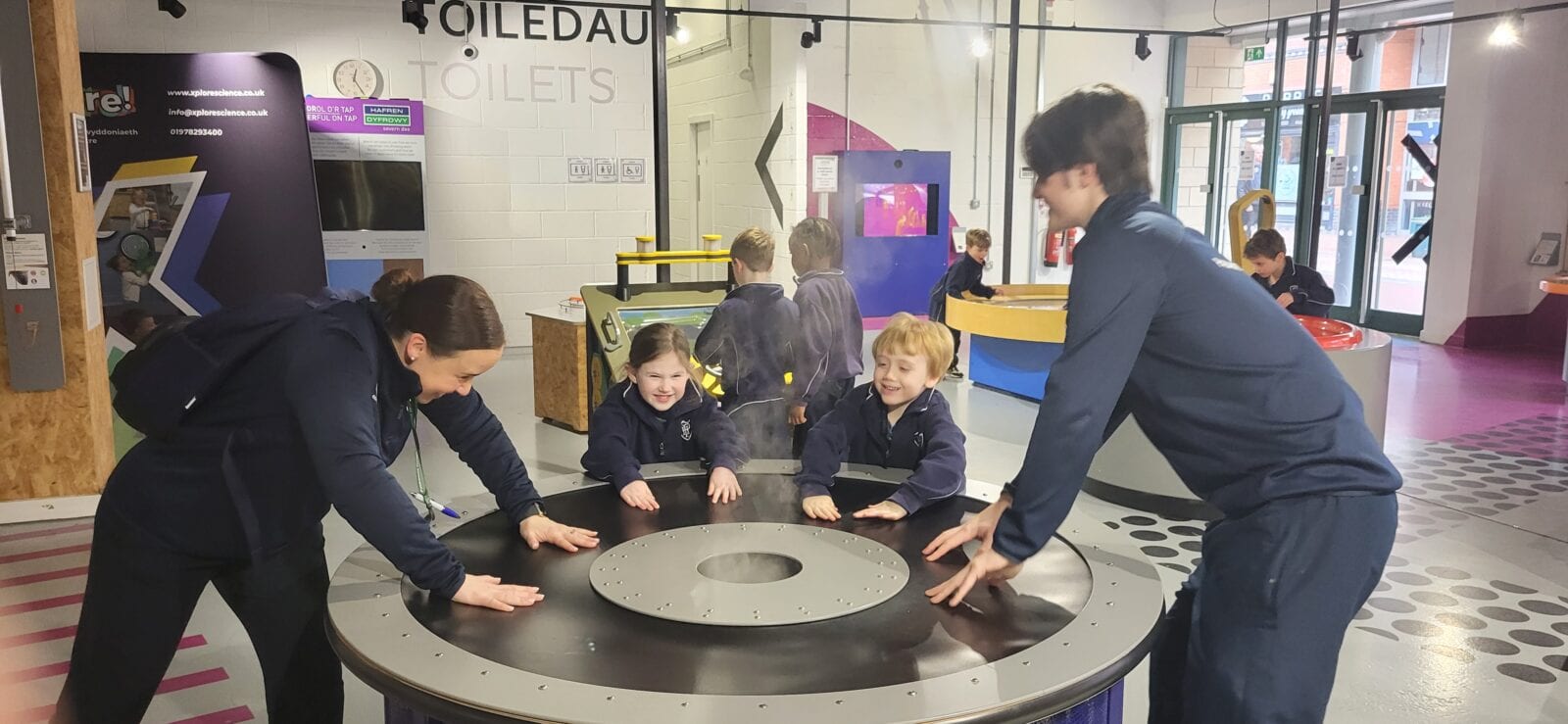 Young children at a science museum exploring activities