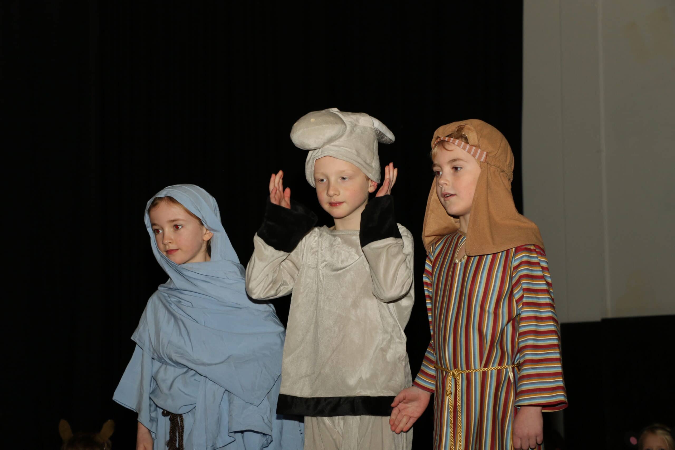 Three pupils performing nativity on stage