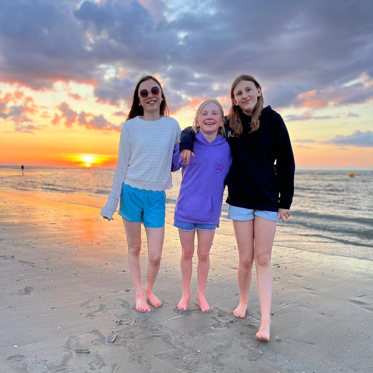 Three girls enjoying the sunset on a beach in France