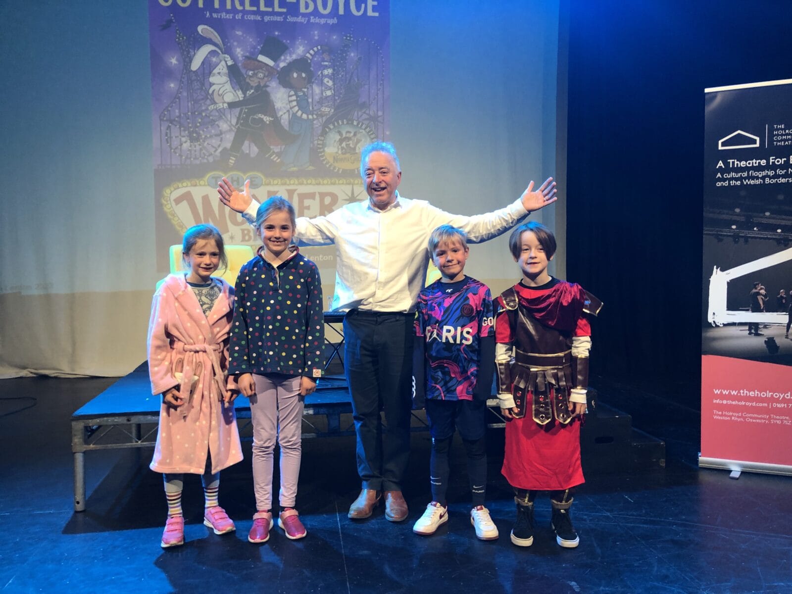 Author with four pupils celebrating world book day