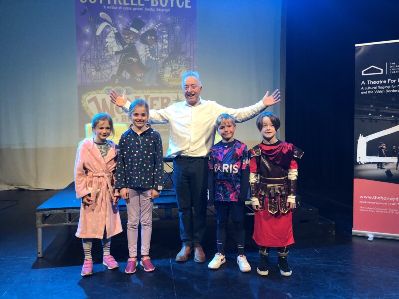 Author with four pupils celebrating world book day