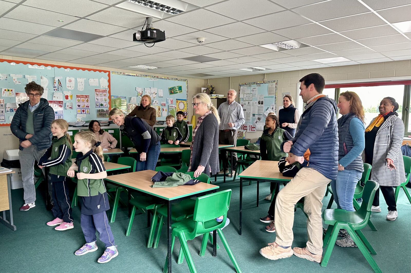 Children and parents singing in school classroom
