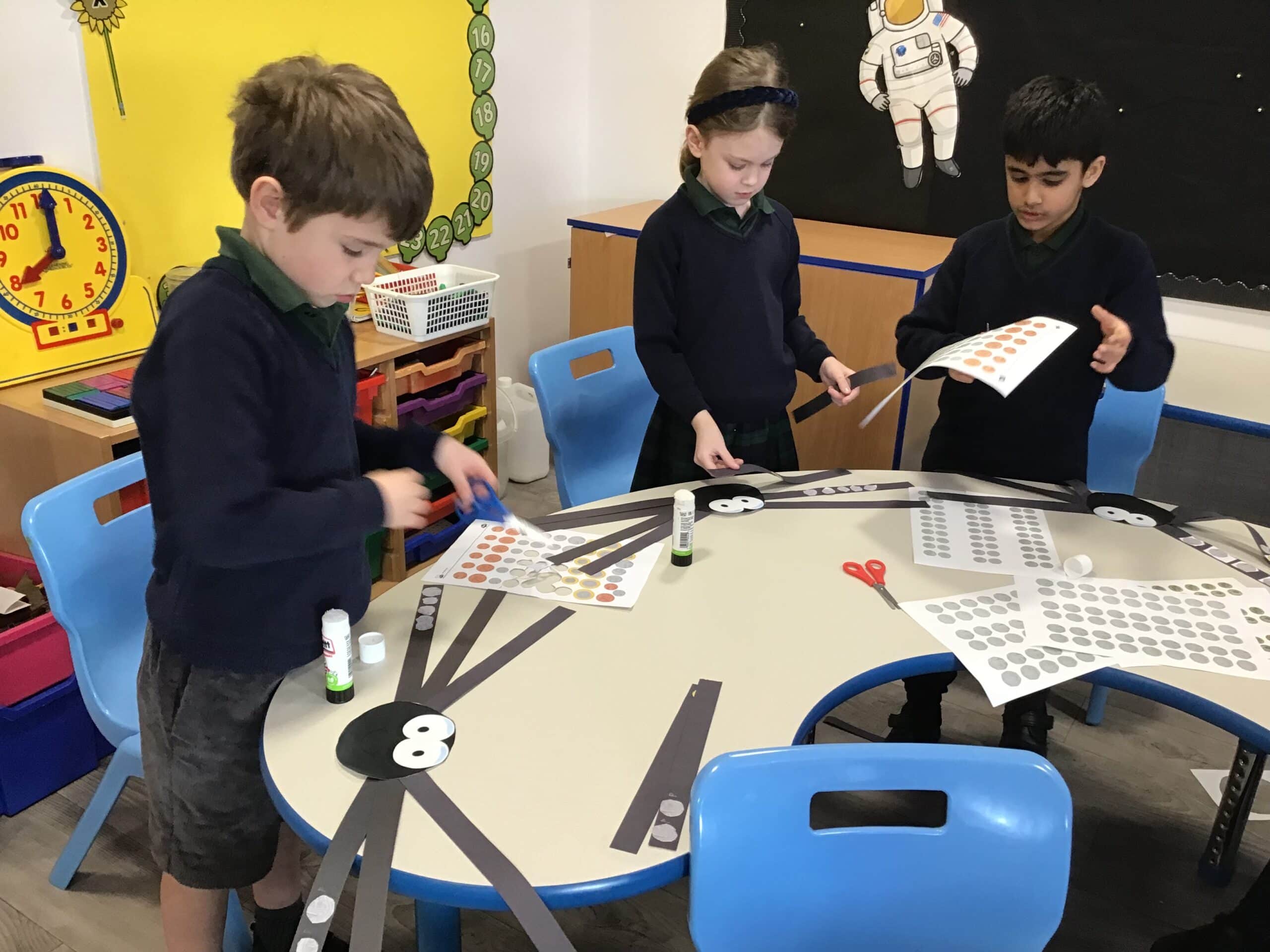 Children making giant paper spiders