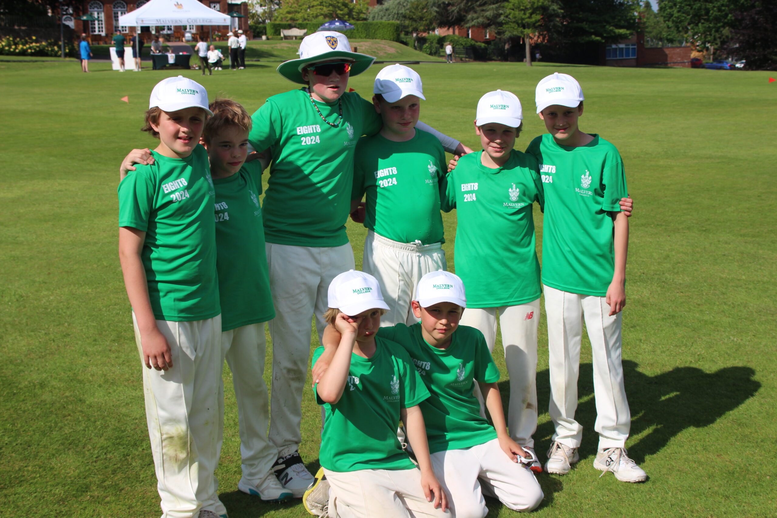 Team of eight Packwood cricketers in bright green tops