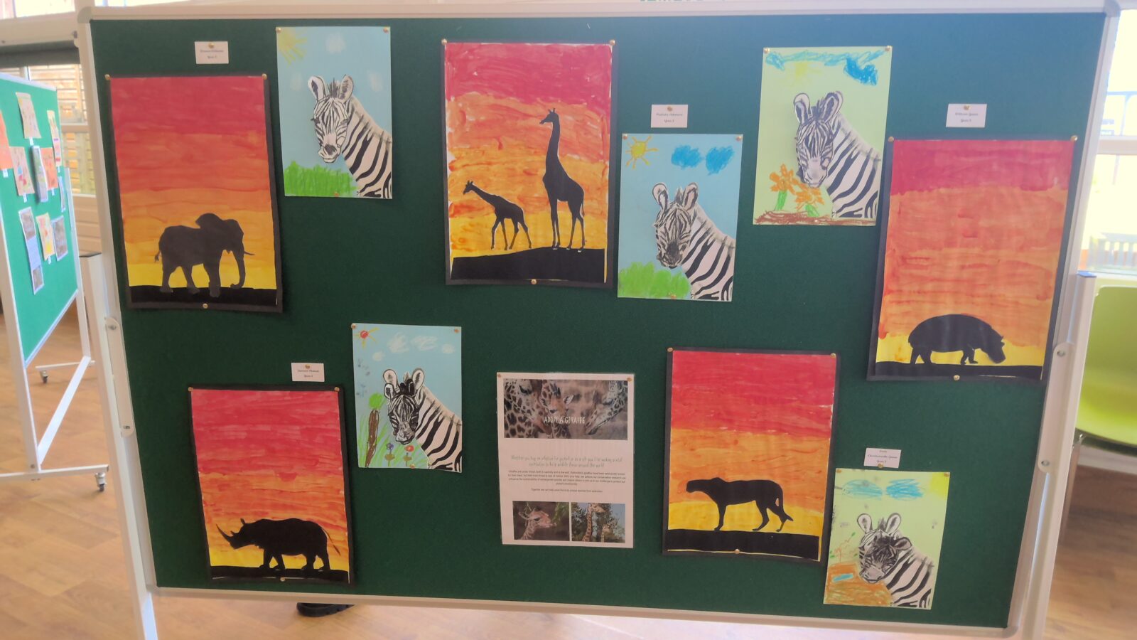 Children's artwork on display featuring African animals